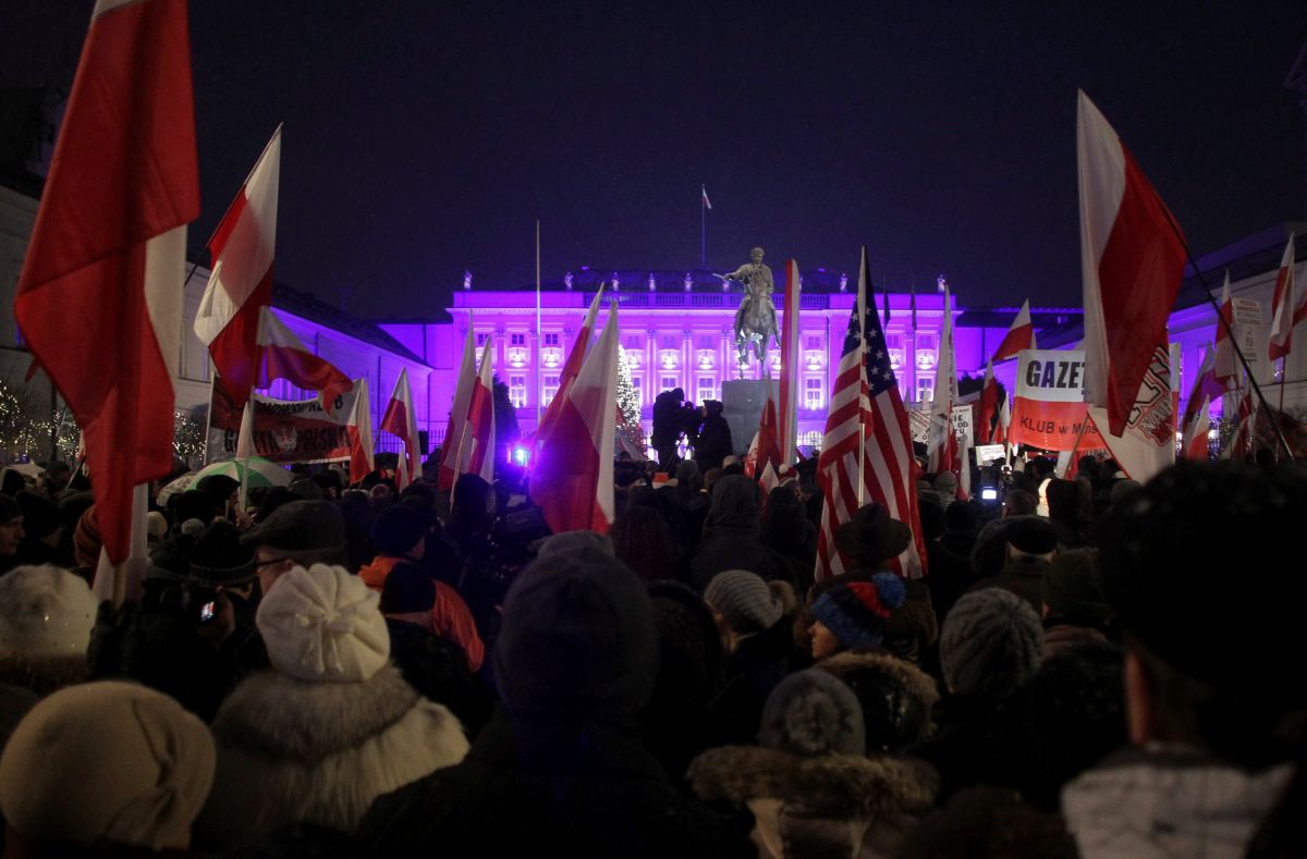 People attend a pro-government rally in front of the Presidential Palace in Warsaw
